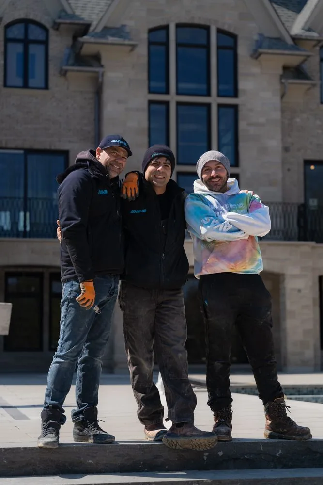 The AVAS Automation team outside a custom home they wired