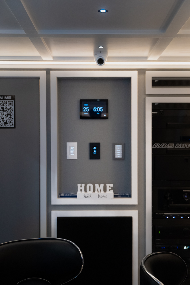 Control4 touchscreen, lighting keypads, and equipment rack inside the AVAS smart home trailer