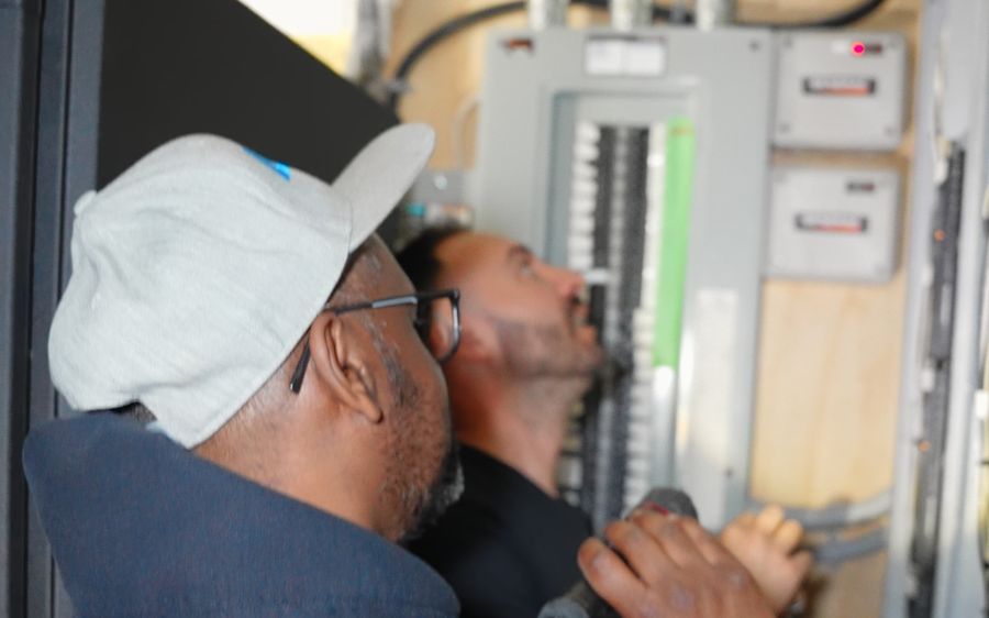 AVAS technicians diagnosing an electrical and control panel on a service call in Toronto