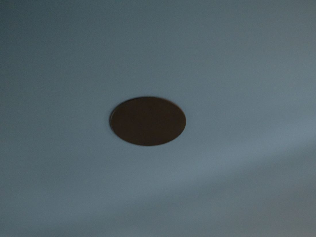 A paintable in-ceiling speaker installed flush in the theatre ceiling