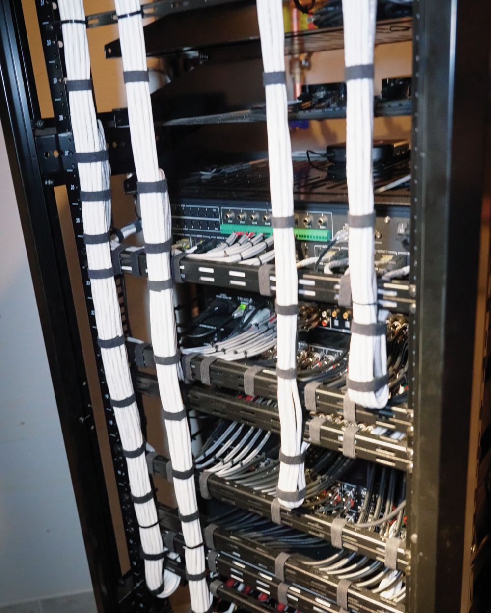 The back of an AVAS Automation equipment rack with every cable laced, dressed, and labelled