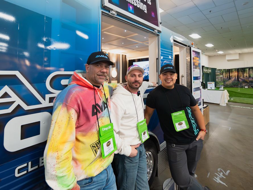 The AVAS Automation team standing in front of the home automation trailer