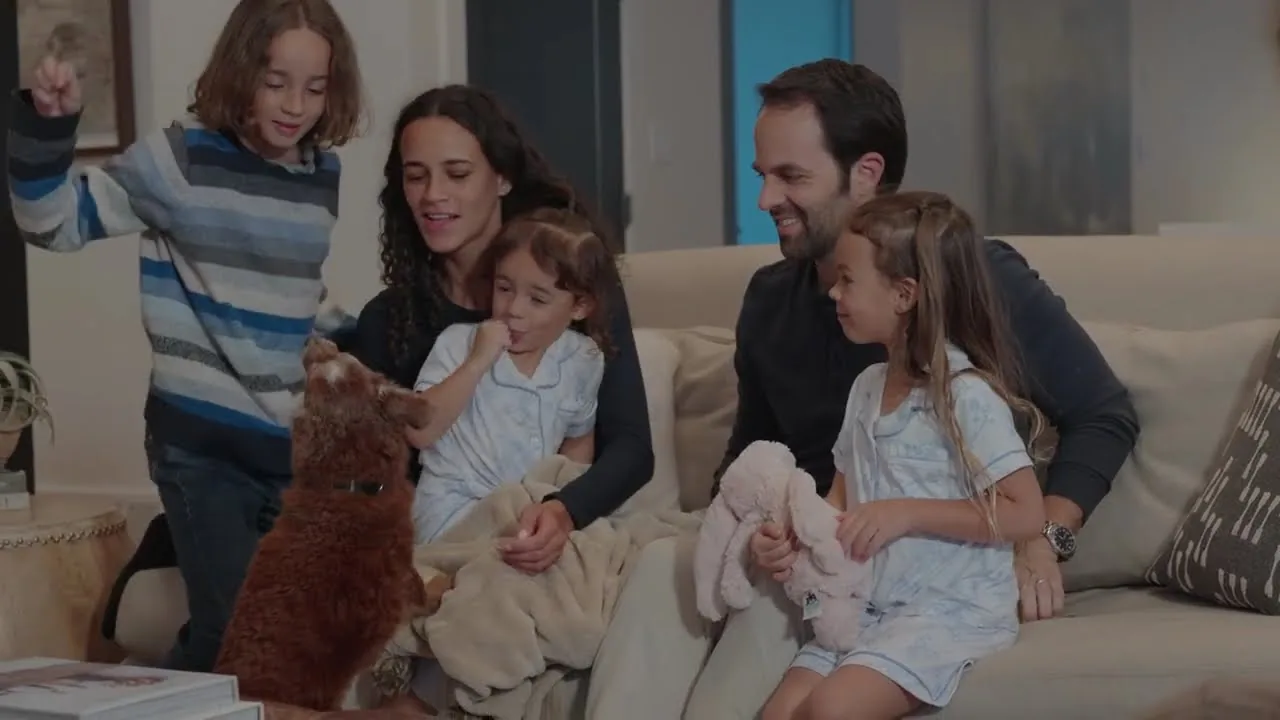 A family relaxing together on the sofa in a smart home living room