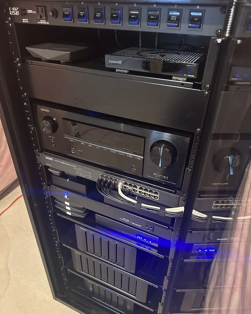 A finished equipment rack with blue lights and neat front panels