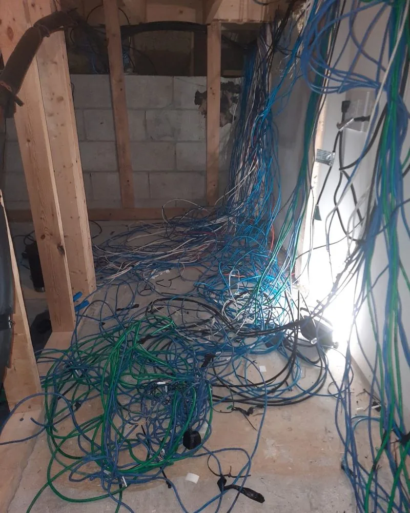 Tangled network cable spilling out of an unfinished utility closet