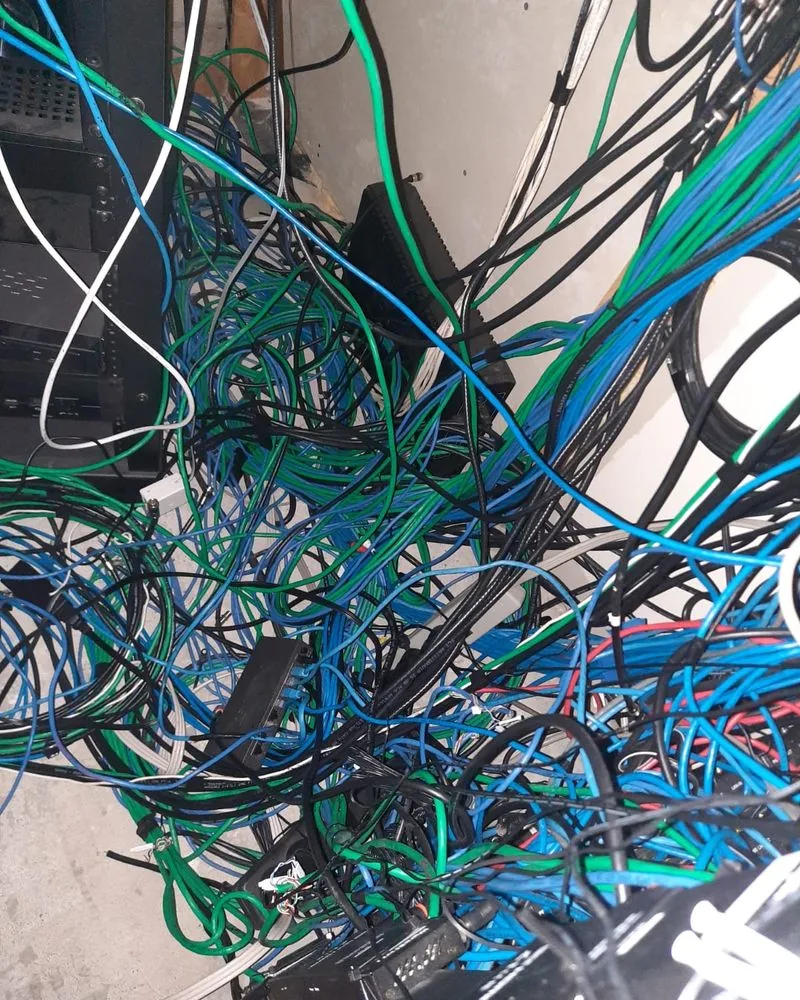 A knot of blue and green network cables with no labels