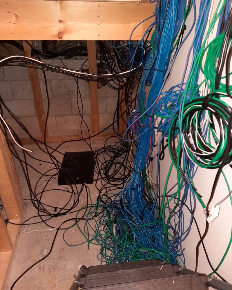 Bundles of cable hanging loose in an unfinished closet