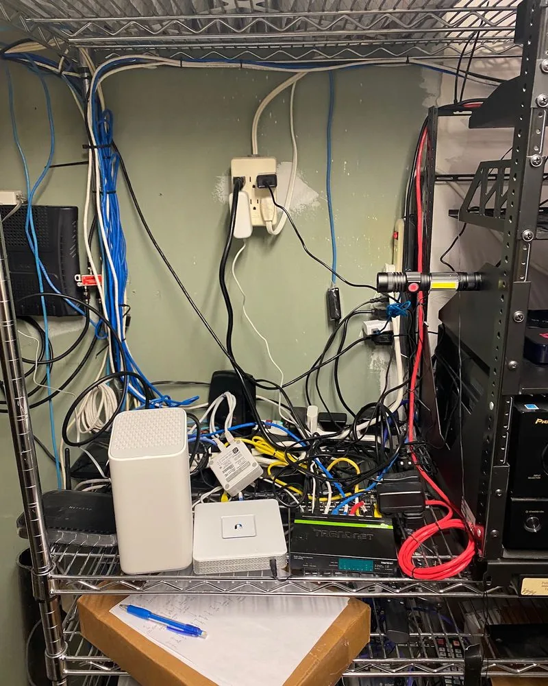 Devices and loose wiring piled on a wire shelf